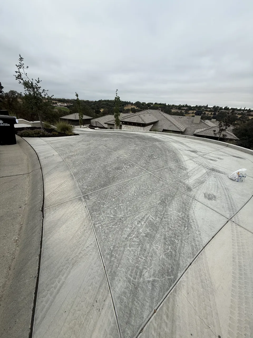Before: weathered, unsealed concrete driveway in Lincoln