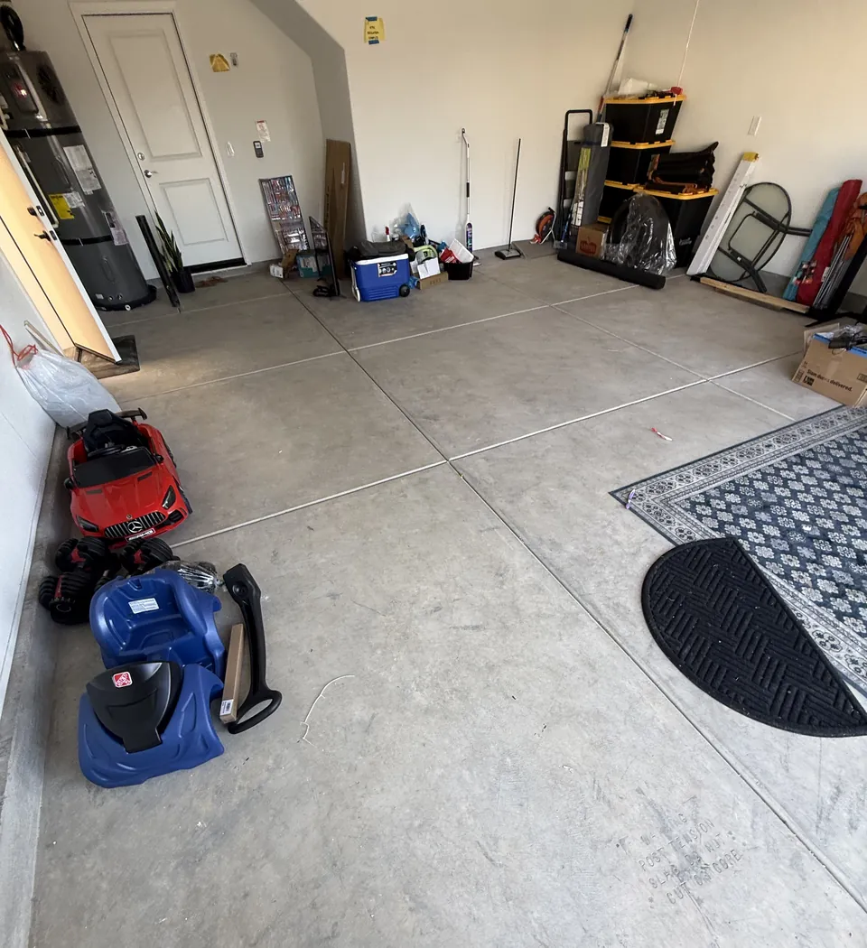 Before: bare concrete two-car garage slab in Natomas