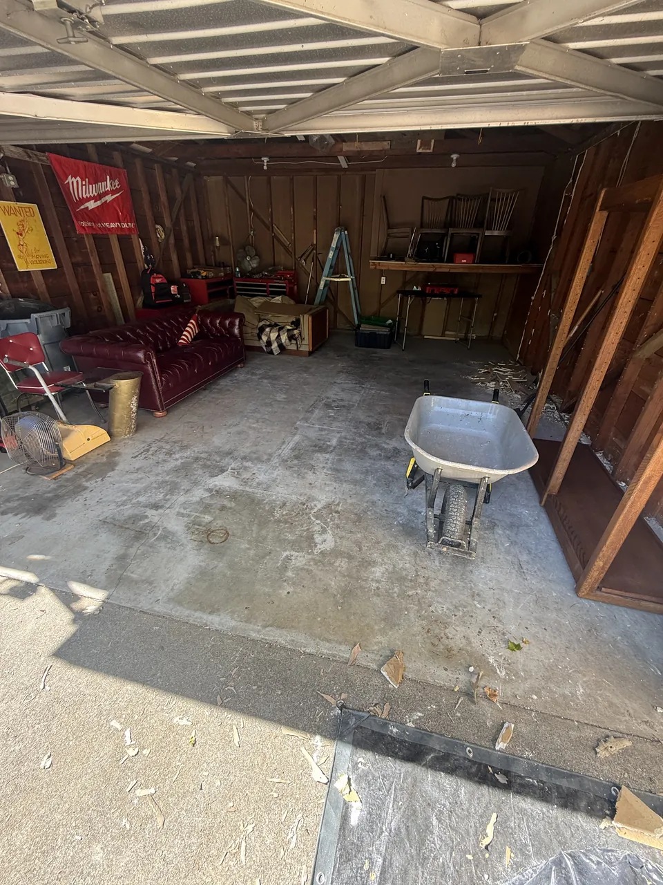Before: stained bare slab in a Land Park detached garage