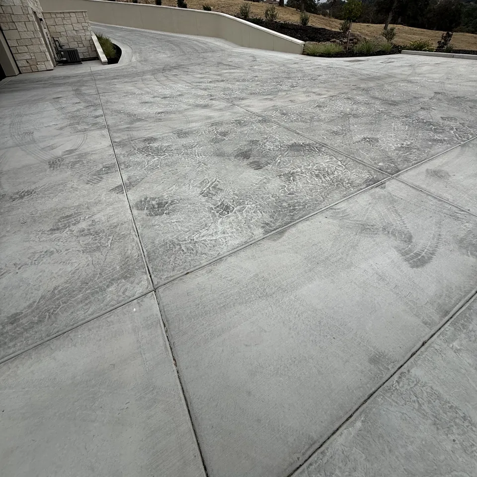 Before: weathered driveway with tire marks