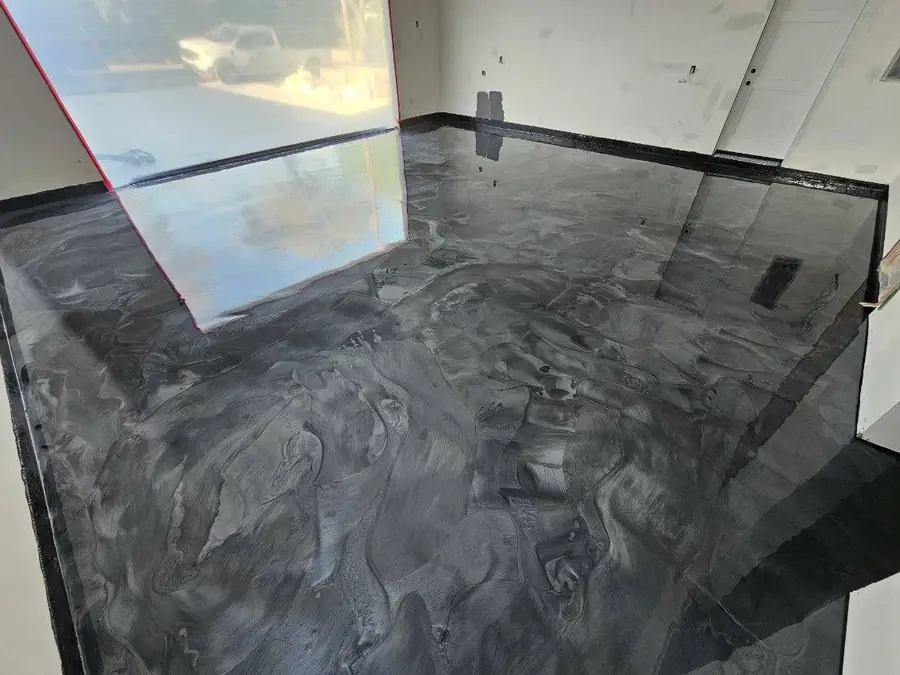 Gray and silver metallic epoxy floor with a marbled, high-gloss finish